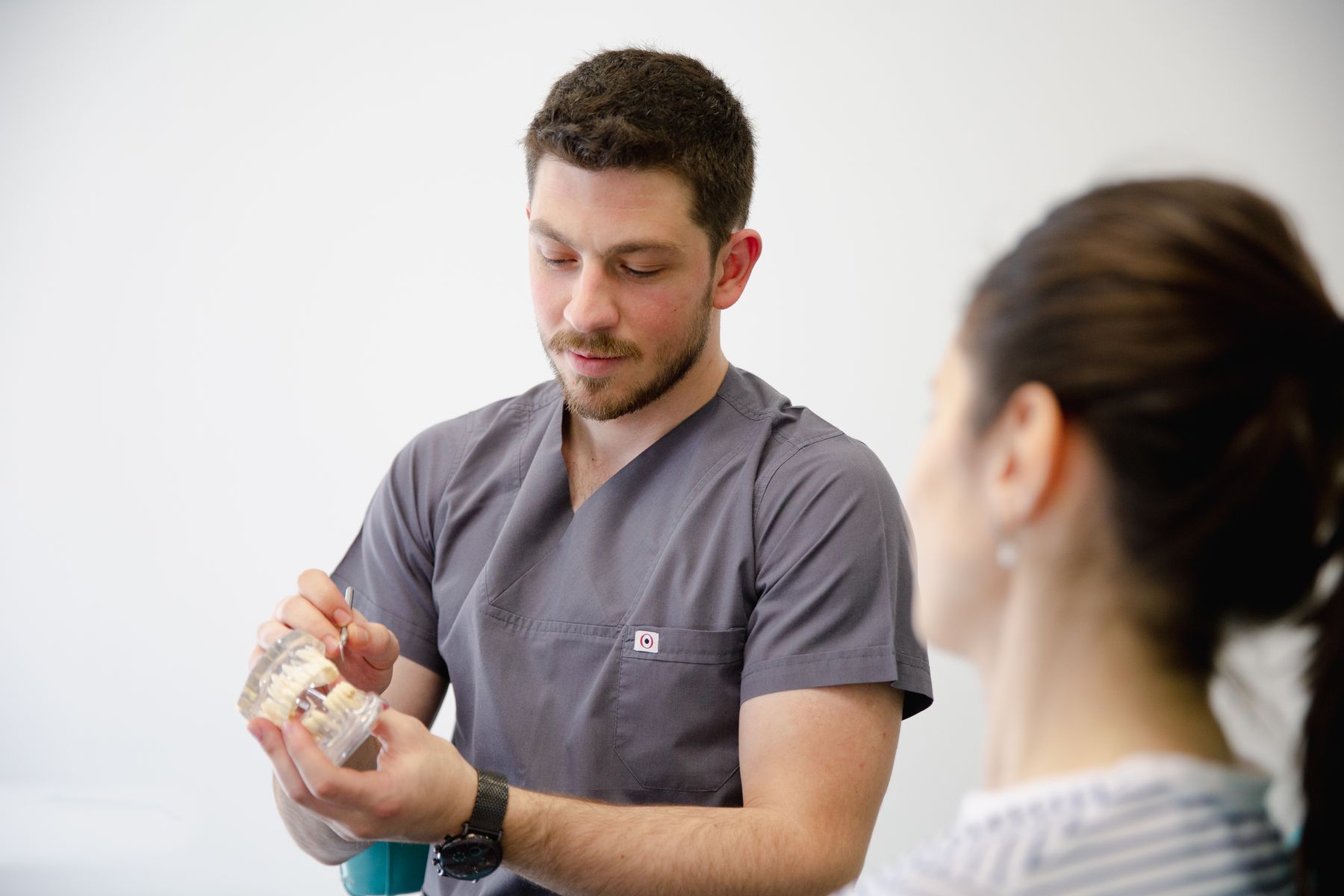 Dentist speaking with a patient during a consultation